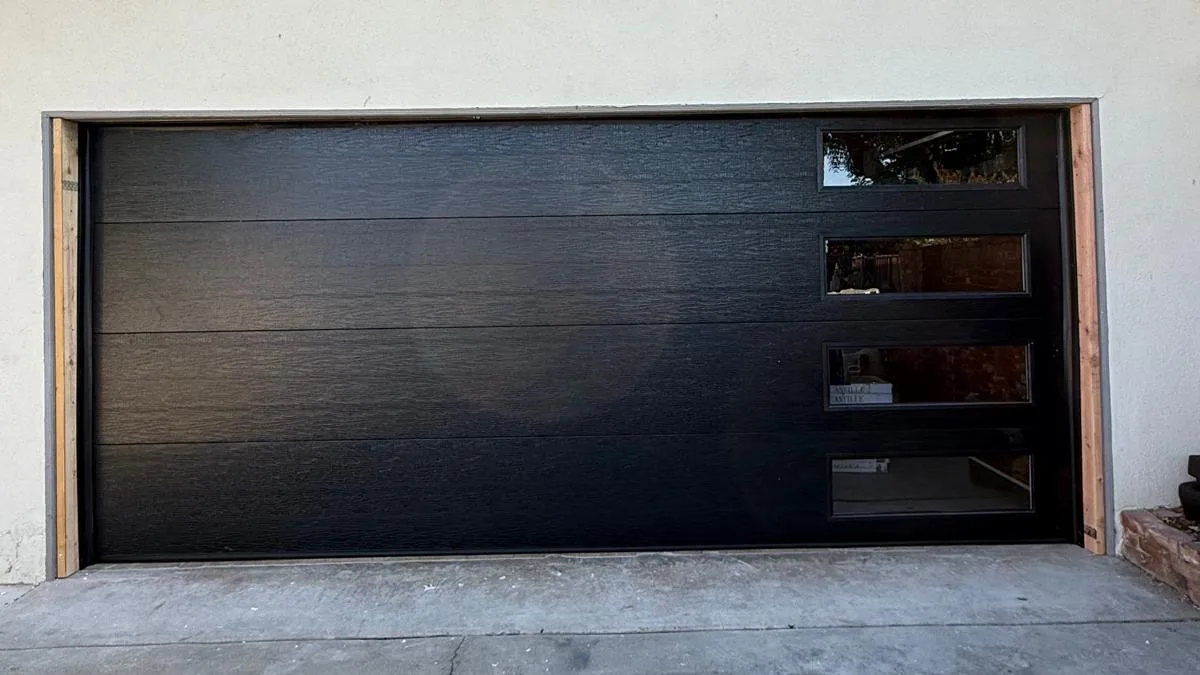 Black modern garage door on a contemporary home