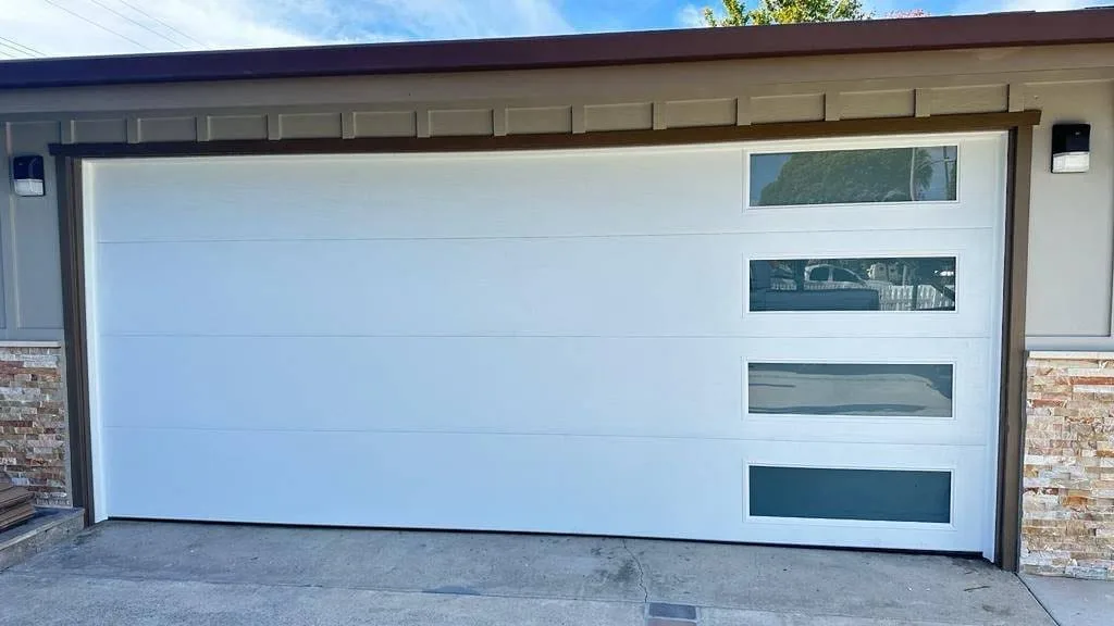 White contemporary garage door with stacked tinted windows